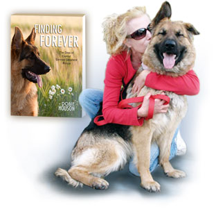 Dobie Houson hugging her dog with Finding Forever book cover in background